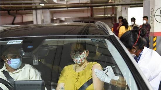 A health worker gives a dose of the Covid-19 vaccine to a woman at a drive-in centre at Dadar in Mumbai on May 22. (File photo) A health worker gives a dose of the Covid-19 vaccine to a woman at a drive-in centre at Dadar in Mumbai on May 22. (File photo)