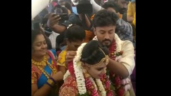 Guests are seen standing behind the couple and there are also visuals of the inside of the aircraft with people sitting and enjoying the function.(ANI) Guests are seen standing behind the couple and there are also visuals of the inside of the aircraft with people sitting and enjoying the function.(ANI)