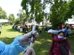 File photo: A health worker prepares a dose of Covid-19 vaccine at a park in Srinagar, 