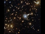 The image shows the galaxy cluster ACO S 295 captured by Nasa's Hubble telescope.