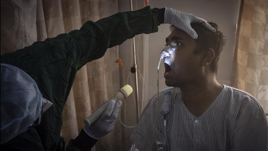 Pune, India - May 22, 2021: A doctor inspects a patient of Mucormycosis or black fungus in a dedicated ward for the similar patients at Noble hospital, Hadapsar in Pune, India, on Saturday, May 22, 2021. (Photo by Pratham Gokhale/Hindustan Times) (Pratham Gokhale/HT Photo) Pune, India - May 22, 2021: A doctor inspects a patient of Mucormycosis or black fungus in a dedicated ward for the similar patients at Noble hospital, Hadapsar in Pune, India, on Saturday, May 22, 2021. (Photo by Pratham Gokhale/Hindustan Times) (Pratham Gokhale/HT Photo)