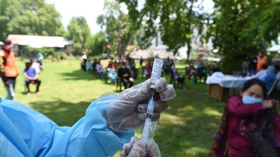 File photo: A health worker prepares a dose of Covid-19 vaccine at a park in Srinagar, (Waseem Andrabi/Hindustan Times) File photo: A health worker prepares a dose of Covid-19 vaccine at a park in Srinagar, (Waseem Andrabi/Hindustan Times)