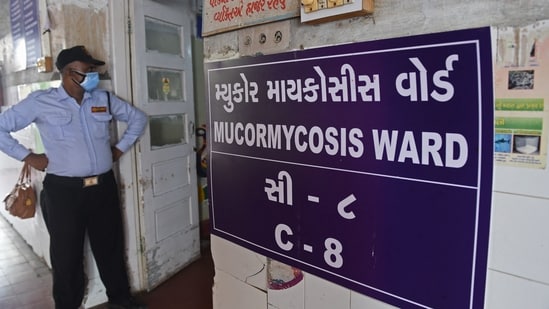 A security guard stands at the entrance of a ward for people infected with black fungus or mucormycosis, a deadly fungal infection, at a civil hospital in Ahmedabad. (AFP Photo)