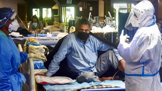 Health workers attend to a Covid-19 patient in New Delhi. (PTI file photo) Health workers attend to a Covid-19 patient in New Delhi. (PTI file photo)