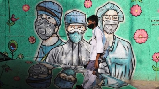 A boy walks past a graffiti amid the spread of Covid-19 on a street in New Delhi. (File photo)