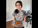 Danya with the cake she baked for her neighbour