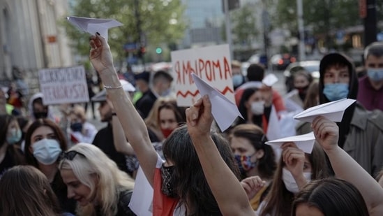 People hold paper planes during a protest against the detention of Belarusian blogger, Roman Protasevich, who was detained as a Ryanair plane that he was on, en route from Athens to Vilnius, was forced to land in Minsk on Sunday, in Warsaw, Poland, May 24, 2021. (Reuters)