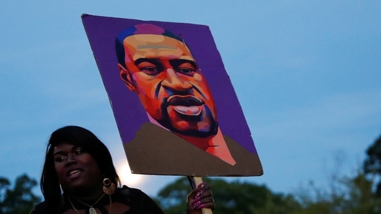 A woman holds a placard depicting George Floyd during a demonstration on the first anniversary of his death, in Brooklyn, New York City, New York, US.(REUTERS)