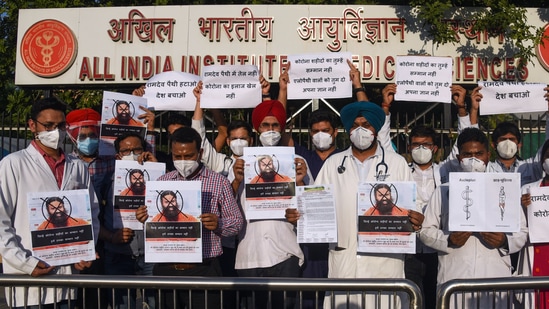 Resident doctors of AIIMS stage a protest against Ramdev over his remarks on allopathy in New Delhi. (ANI Photo)