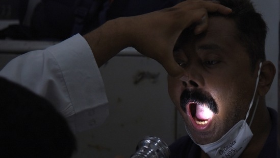 A doctor checks a Covid patient for mucormycosis or black fungus symptoms at a hospital in Mumbai. (Bachchan Kumar/HT Photo)