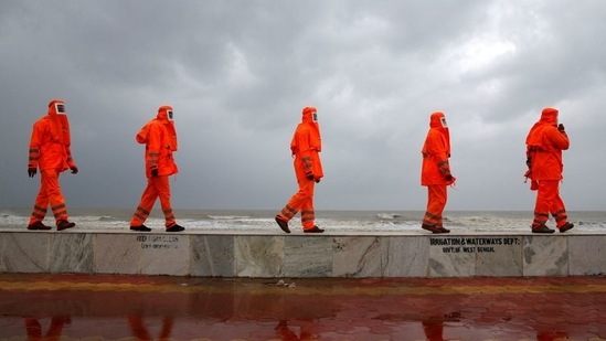 Members of the National Disaster Response Force (NDRF) patrol along a shore ahead of Cyclone Yaas in Digha on May 25. Efforts are being made to evacuate more people from the coastal areas of Digha, West Bengal Chief Minister Mamata Banerjee said on May 26. Digha in East Midnapore shares border with Odisha's Balasore district.(Rupak De Chowdhury / REUTERS)