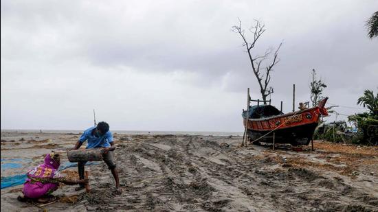 Villagers try to save their boat at Fraserganj, ahead of landfall of Cyclone Yaas, in South 24 Parganas district of West Bengal on Tuesday, May 25. (PTI)