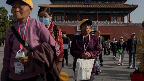 Tourists leave the Forbidden City in Beijing on May 25, 2021. (AFP) Tourists leave the Forbidden City in Beijing on May 25, 2021. (AFP)