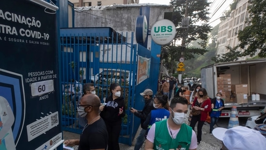 People wait in line outside a community medical center to get a shot of the Pfizer vaccine for Covid-19 in Sao Paulo, Brazil (AP). People wait in line outside a community medical center to get a shot of the Pfizer vaccine for Covid-19 in Sao Paulo, Brazil (AP).