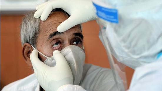 A doctor examines a Covid-19 patient for black fungus infection. (PTI) A doctor examines a Covid-19 patient for black fungus infection. (PTI)