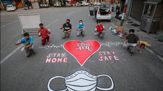 Artists of Red Cross society paint a message to spread awareness about Covid-19 in Jammu on May 18. (File photo) Artists of Red Cross society paint a message to spread awareness about Covid-19 in Jammu on May 18. (File photo)