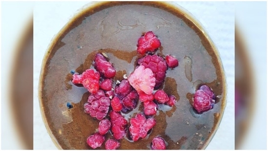 Raspberry chocolate smoothie bowl: Add half a frozen banana, 1 handful spinach, 1/2 cup raspberries, 1 tablespoon almond or cashew nut butter, 2 tablespoons raw cocoa powder, a cup of unsweetened almond, hemp or coconut milk to a blender and blend. Serve in a bowl and top it with your favourite fruits and nuts.(Instagram/journeytogreensness)