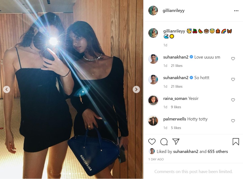 Suhana and her friend pose in black dresses.