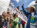 Members of the environmental group MilieuDefensie celebrate the verdict of the Dutch environmental organisation's case against Royal Dutch Shell Plc, outside the Palace of Justice courthouse in The Hague. Members of the environmental group MilieuDefensie celebrate the verdict of the Dutch environmental organisation's case against Royal Dutch Shell Plc, outside the Palace of Justice courthouse in The Hague.
