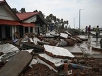 People walk through a damaged shoreline in West Bengal after Cyclone Yaas hit India's eastern coast.