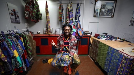 Rwandan-born fashion designer and visual artist Eli Gold sits amongst his designs at his studio in Cape Town, South Africa, May 12 ,2021. Picture taken May 12 ,2021. (REUTERS/Mike Hutchings)