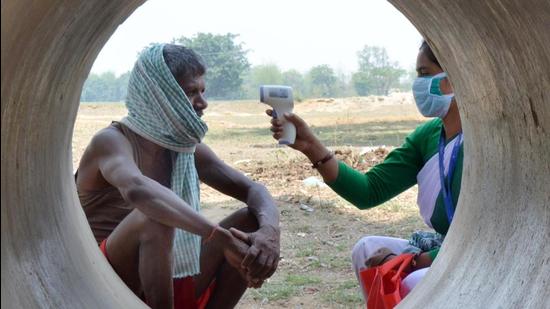 A Jharkhand government health worker conducts thermal screening of a villager at Chaite village in Namkum block of Ranchi earlier this month. (File photo)