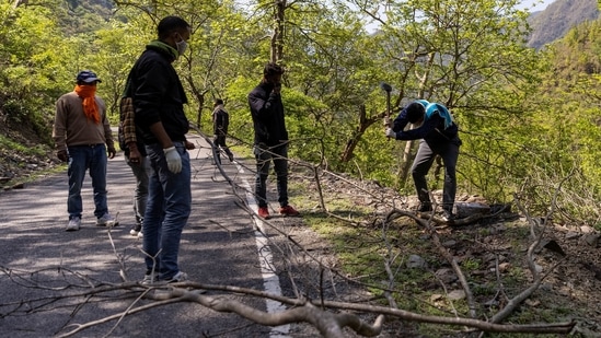 Rajesh Kumar, Devi's nephew, chops wood from a forest for her cremation, in Pauri Garhwal, on May 24. India's Covid-19 caseload stands at 27.16 million, with 311,388 deaths as of May 26 according to government data. But some experts estimate numbers are far higher, due in part to low testing rates in India's hinterlands where Covid-19 cases are spreading rapidly.(Danish Siddiqui / REUTERS)