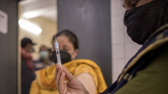 A health worker prepares a dose of Covid-19 vaccine at the heath center in the village of Bazrak, Uttar Pradesh. (Bloomberg file photo)