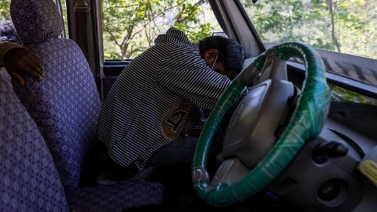Suresh Kumar, 43, mourns inside a jeep ahead of his wife Pramila Devi's cremation in Pauri Garhwal on May 24. Devi's eldest daughter got married and moved away in late April after the family hosted a ceremony attended by over two dozen people, Suresh Kumar told Reuters.(Danish Siddiqui / REUTERS)