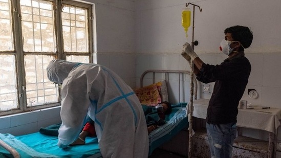 Pramila Devi undergoes treatment at a government dispensary in Kaljikhal on May 23. It was not until 10 days later since Devi’s health deteriorated that Kumar, who has no income and depends on handouts, took her to a nearby dispensary that has been turned into a small Covid-19 facility with four beds.(Danish Siddiqui / REUTERS)