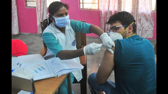 A man being inoculated with Covishield at a government school in Sector 45, Chandigarh, on Thursday. (Ravi Kumar/HT) A man being inoculated with Covishield at a government school in Sector 45, Chandigarh, on Thursday. (Ravi Kumar/HT)