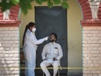 A health worker collects a swab sample from man to test for Covid-19 infection, at a school in Janakpuri, New Delhi, on May 26. Delhi’s Covid-19 graph continued its downward trajectory on May 27, with daily infections falling sharply. Delhi added 1,072 new cases of Covid-19, over 400 fewer than the previous day, HT reported.