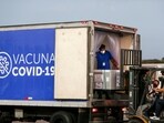 Containers of AstraZeneca vaccines under the Covax scheme are loaded onto a truck after arriving at an airport, in San Luis Talpa, El Salvador.(Reuters)