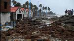 People walk through a damaged shoreline after Cyclone Yaas hit eastern coast in the Bay of Bengal, at a beach in Shankarpur, some 180 km from Kolkata on May 27. (AFP) People walk through a damaged shoreline after Cyclone Yaas hit eastern coast in the Bay of Bengal, at a beach in Shankarpur, some 180 km from Kolkata on May 27. (AFP)