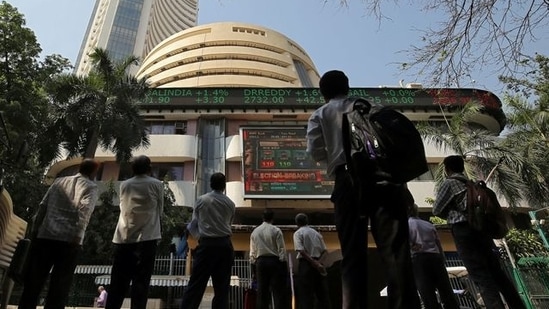 People look at a screen displaying the Sensex results on the facade of the Bombay Stock Exchange (BSE) building in Mumbai (Reuters file photo)