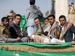 Armed Houthi followers ride on the back of a truck after participating in a funeral of Houthi fighters killed in fighting against government forces.