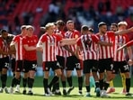 Brentford players celebrate after winning the Championship Play-Off Final