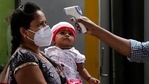 A health worker checks body temperature of a traveler as a precaution against the coronavirus before allowing her to proceed at train station in Mumbai, India, Thursday, May 27, 2021.(AP) A health worker checks body temperature of a traveler as a precaution against the coronavirus before allowing her to proceed at train station in Mumbai, India, Thursday, May 27, 2021.(AP)