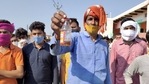 A villager shows a bottle of spurious liquor sold by a licensed vendor in Aligarh district. (PTI Photo) A villager shows a bottle of spurious liquor sold by a licensed vendor in Aligarh district. (PTI Photo)