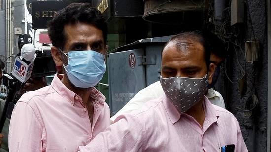 Police bring businessman Navneet Kalra to Khan Market in New Delhi. (ANI Photo) Police bring businessman Navneet Kalra to Khan Market in New Delhi. (ANI Photo)