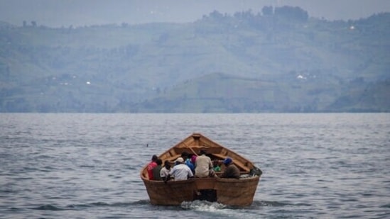 Residents travel by boat to flee across Lake Kivu in the direction of South Kivu province, at the port of Kituku in Goma, in eastern Congo Friday, May 28, 2021. (AP)
