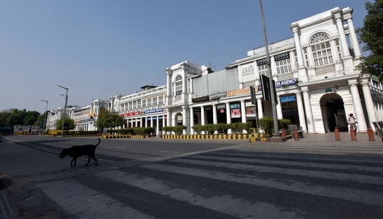 A dogs walks along a deserted Connaught Place during the Covid-19 induced lockdown, in New Delhi. (Sanjeev Verma/ Hindustan Times)