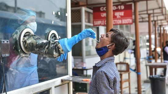 A healthcare worker collects swab sample. (PTI) A healthcare worker collects swab sample. (PTI)