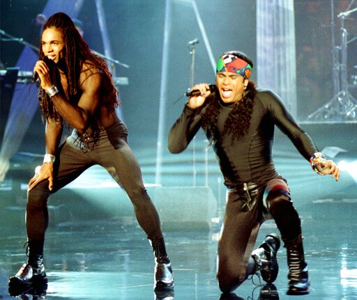 FILE - In this Oct. 26, 1992 file photo, Fabrice Morvan, left, and Rob Pilatus of Milli Vanilli perform during the taping of the Arsenio Hall Show in Los Angeles. John Davis, one of the real singers behind the lip-synching duo, died of the coronavirus this week. The South Carolina native was 66. Davis was credited as a backup singer on the pop duo's albums. (AP Photo/Craig Fujii, File)(AP)
