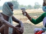 A Jharkhand government health worker conducts thermal screening of a villager at Chaite village in Namkum block of Ranchi earlier this month. (File photo)