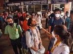 A health worker collects swab sample from a passenger for Covid-19 testing at Patna railway station. A health worker collects swab sample from a passenger for Covid-19 testing at Patna railway station.