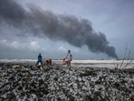 Impoverished Sri Lankans salvage wreckage washed off to the shore from the burning Singaporean ship MV X-Press Pearl which is anchored off Colombo port at Kapungoda, outskirts of Colombo, Sri Lanka.(AP) Impoverished Sri Lankans salvage wreckage washed off to the shore from the burning Singaporean ship MV X-Press Pearl which is anchored off Colombo port at Kapungoda, outskirts of Colombo, Sri Lanka.(AP)