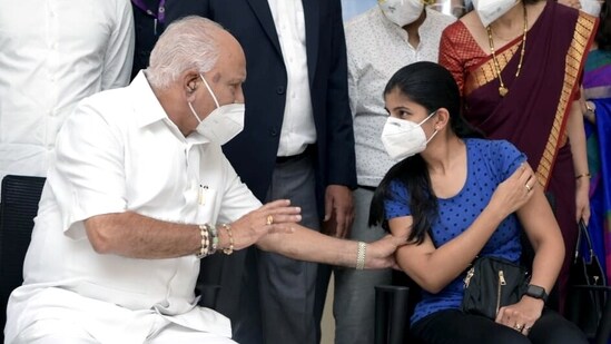 Chief Minister B.S. Yediyurappa interacts with a girl while inaugurating the COVID vaccination drive for 18+ years, symbolically at Bowring and lady Curzon hospital, in Bengaluru on Saturday. (ANI Photo)
