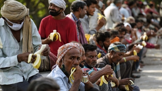 People eat food during the Langar Sewa near Kashmiri Gate, in New Delhi on Saturday. (ANI Photo) People eat food during the Langar Sewa near Kashmiri Gate, in New Delhi on Saturday. (ANI Photo)