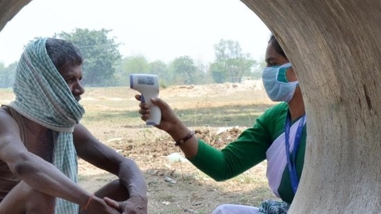 A Jharkhand government health worker conducts thermal screening of a villager at Chaite village in Namkum block of Ranchi earlier this month. (File photo)